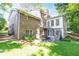 Backyard view of a brick house with an elevated sunroom and a wooden staircase at 5287 Vernon Lake Dr, Atlanta, GA 30338