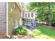 Brick home featuring an elevated sunroom with a private stairwell to the backyard at 5287 Vernon Lake Dr, Atlanta, GA 30338