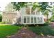 Brick house with sunroom addition featuring an external stairwell with wooded background at 5287 Vernon Lake Dr, Atlanta, GA 30338