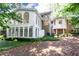 Rear exterior view of house showcasing elevated sunroom addition with expansive windows at 5287 Vernon Lake Dr, Atlanta, GA 30338