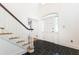 View of home's foyer, with stairs, tile flooring, and natural light shining through sidelight windows at 5287 Vernon Lake Dr, Atlanta, GA 30338