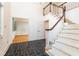 Home foyer featuring black tile floors, chandelier, staircase with white banister, and open doorway at 5287 Vernon Lake Dr, Atlanta, GA 30338