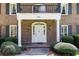 Close-up shot of the classic facade of the house, featuring a wrought iron balcony and pillared entrance at 5287 Vernon Lake Dr, Atlanta, GA 30338