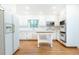Spacious kitchen features white cabinets, stainless appliances, and view to dining nook at 5287 Vernon Lake Dr, Atlanta, GA 30338