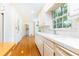 Classic kitchen with white cabinets, bright window, and easy access to dining area at 5287 Vernon Lake Dr, Atlanta, GA 30338