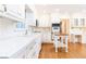 Well-lit kitchen featuring white cabinets, tiled backsplash, and modern appliances, perfect for cooking at 5287 Vernon Lake Dr, Atlanta, GA 30338