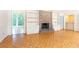 Cozy living room with a brick fireplace, built-in bookcases, and hardwood floors at 5287 Vernon Lake Dr, Atlanta, GA 30338