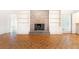 Spacious living room features brick fireplace, parquet floors, and built-in shelving at 5287 Vernon Lake Dr, Atlanta, GA 30338