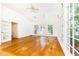 Sun-drenched sun room boasts hardwood floors, skylights, and expansive windows with backyard views at 5287 Vernon Lake Dr, Atlanta, GA 30338