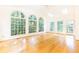 This sunny sun room boasts hardwood floors, skylights, a ceiling fan, and large arched windows at 5287 Vernon Lake Dr, Atlanta, GA 30338