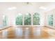 Bright sun room boasts hardwood floors, skylights, large arched windows, and a ceiling fan at 5287 Vernon Lake Dr, Atlanta, GA 30338