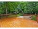 A wood back deck offers outdoor living with yard, fence and planting bed at 12290 Greenmont Walk, Alpharetta, GA 30009