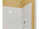Bright bathroom showing bathtub with white tiled walls and chrome shower head at 12290 Greenmont Walk, Alpharetta, GA 30009