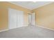 Bedroom with neutral carpet and a double door closet, offering ample storage at 12290 Greenmont Walk, Alpharetta, GA 30009
