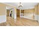 Open-concept dining room with hardwood floors and seamless access to living room and kitchen at 12290 Greenmont Walk, Alpharetta, GA 30009