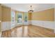 Elegant dining room with hardwood floors, wainscoting, and large windows for natural light at 12290 Greenmont Walk, Alpharetta, GA 30009