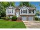 Charming two-story home boasts a brick and siding exterior and a well-maintained lawn at 12290 Greenmont Walk, Alpharetta, GA 30009