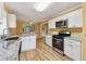 Bright kitchen boasts stainless appliances, granite countertops, hardwood floors, and a view to the backyard at 12290 Greenmont Walk, Alpharetta, GA 30009