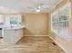 Eat-in kitchen features bright natural light, white cabinets, breakfast bar, ceiling fan, hardwood floors and neutral decor at 12290 Greenmont Walk, Alpharetta, GA 30009