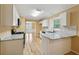 Open kitchen with stainless steel appliances, gas range, white cabinets, stone countertops, and hardwood flooring at 12290 Greenmont Walk, Alpharetta, GA 30009
