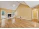 Bright living room featuring hardwood floors, fireplace, vaulted ceiling, and backyard access at 12290 Greenmont Walk, Alpharetta, GA 30009