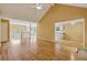 Open-concept living room with hardwood floors, ceiling fan, and seamless access to the kitchen at 12290 Greenmont Walk, Alpharetta, GA 30009