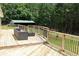 The back deck offers wooden railings, stylish patio seating, and a view of the spacious backyard at 3129 Etchison Rd, Loganville, GA 30052