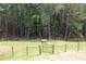 Spacious fenced backyard with a small storage shed and wooded surroundings at 3129 Etchison Rd, Loganville, GA 30052