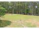 Lush backyard boasts privacy with trees and a well-maintained lawn; ideal for outdoor living at 3129 Etchison Rd, Loganville, GA 30052