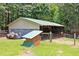 Storage building with open storage and green metal roof at 3129 Etchison Rd, Loganville, GA 30052