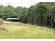 View of fenced pastures and large barn at 3129 Etchison Rd, Loganville, GA 30052
