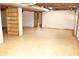 Unfinished basement area showing the open space with exposed ceiling and sliding door access at 3129 Etchison Rd, Loganville, GA 30052