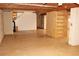 Unfinished basement area showing stairs, exposed ceiling, and sliding door access at 3129 Etchison Rd, Loganville, GA 30052