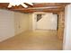 The unfinished basement features concrete walls, an exposed ceiling, and a doorway to the stairs at 3129 Etchison Rd, Loganville, GA 30052