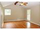 Spacious bedroom featuring hardwood floors, a ceiling fan, and bright natural light from windows at 3129 Etchison Rd, Loganville, GA 30052