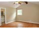 Well-lit bedroom with hardwood floors, a ceiling fan, and a convenient en-suite bathroom at 3129 Etchison Rd, Loganville, GA 30052