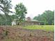 Ranch-style home on a grassy lot with a brick chimney and covered porch at 3129 Etchison Rd, Loganville, GA 30052