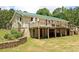 Rear exterior featuring a two-story deck perfect for entertaining with a spacious lawn at 3129 Etchison Rd, Loganville, GA 30052