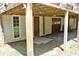 Covered space below the deck features a door, window, and access to storage, offering convenience at 3129 Etchison Rd, Loganville, GA 30052