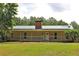 Charming single-story home with a metal roof and a cozy front porch and large front yard at 3129 Etchison Rd, Loganville, GA 30052