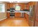 Spacious kitchen with stainless steel appliances, wood cabinets, and hardwood floors at 3129 Etchison Rd, Loganville, GA 30052