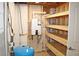 Utility room featuring a tankless water heater, expansion tank, and open shelves for storage at 3129 Etchison Rd, Loganville, GA 30052