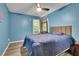 Comfortable bedroom with blue walls, a window, and a plush queen bed at 3202 Ivy Station Way, Duluth, GA 30096