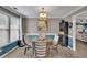 Inviting dining room with round table, four chairs, modern light fixture, and wainscoting at 3202 Ivy Station Way, Duluth, GA 30096