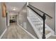 Open entryway with hardwood flooring, stairs with white risers and black handrail, and interior view at 3202 Ivy Station Way, Duluth, GA 30096