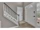 Entryway featuring wood-look flooring, staircase with gray handrail, and a glass-accented front door at 3202 Ivy Station Way, Duluth, GA 30096