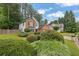 Charming two-story home with a brick and siding exterior, two-car garage and well-manicured lawn at 3202 Ivy Station Way, Duluth, GA 30096