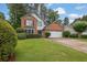 Charming two-story home with a brick and siding exterior, two-car garage and well-manicured front lawn at 3202 Ivy Station Way, Duluth, GA 30096