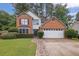 Charming two-story home with a brick and siding exterior, two-car garage and well-manicured front yard at 3202 Ivy Station Way, Duluth, GA 30096