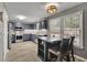 Modern kitchen with dark cabinets, stainless steel appliances, and a center island at 3202 Ivy Station Way, Duluth, GA 30096